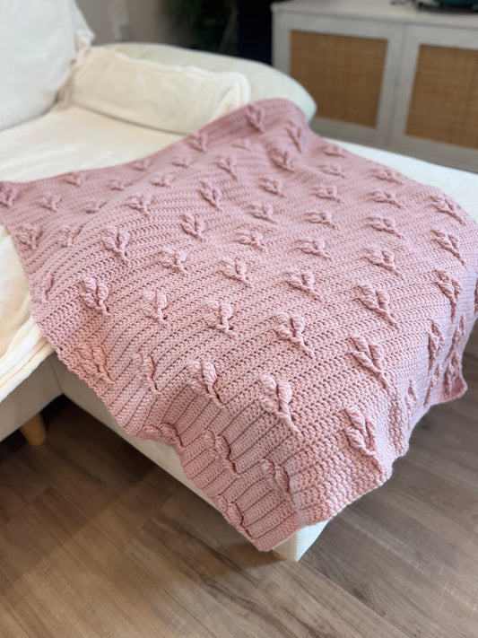 Blush pink heirloom crochet blanket with raised petal stitch, handmade by The Crochet Corral in Florida