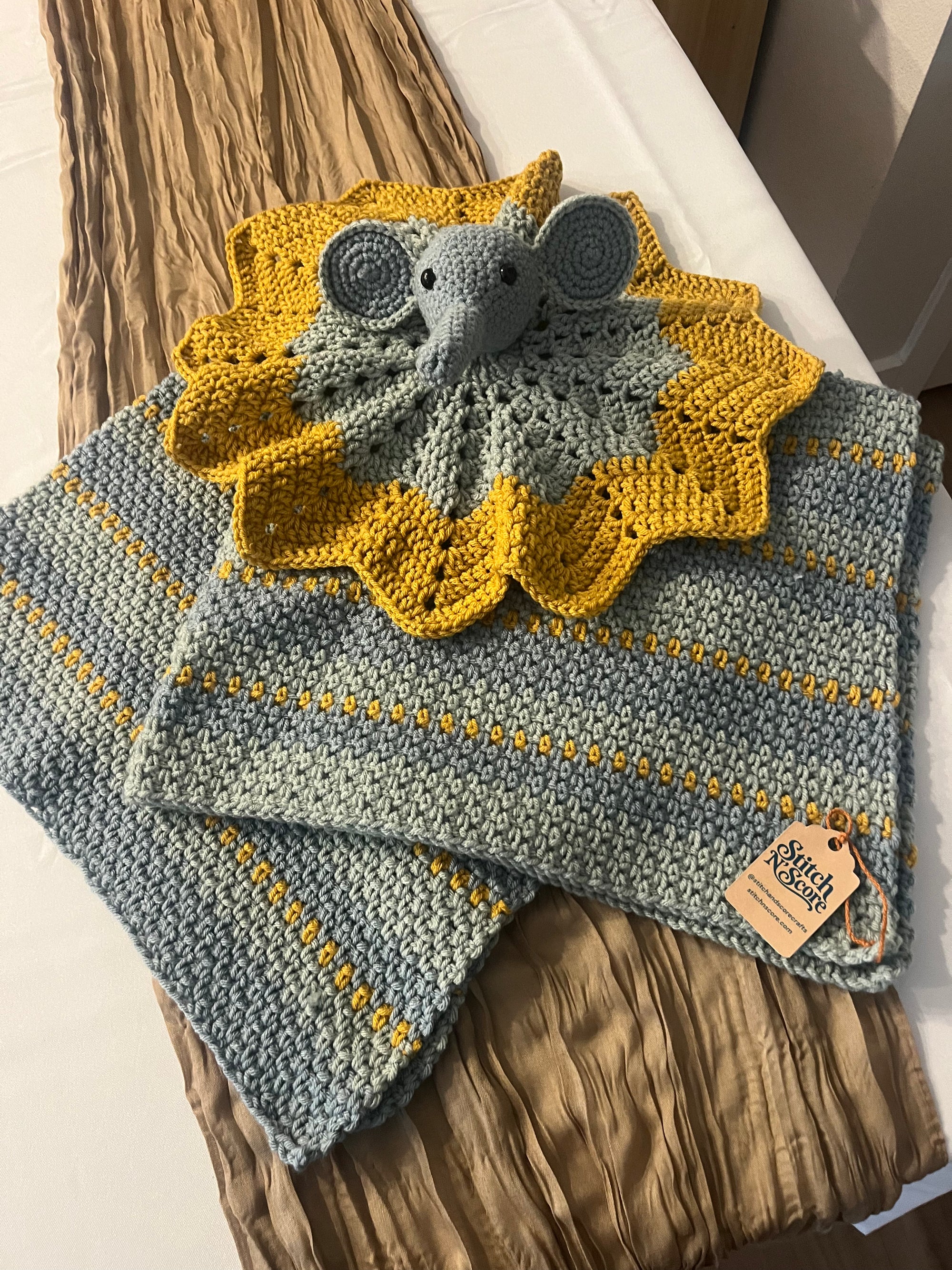 Crochet elephant lovey with a matching grey and mustard baby blanket