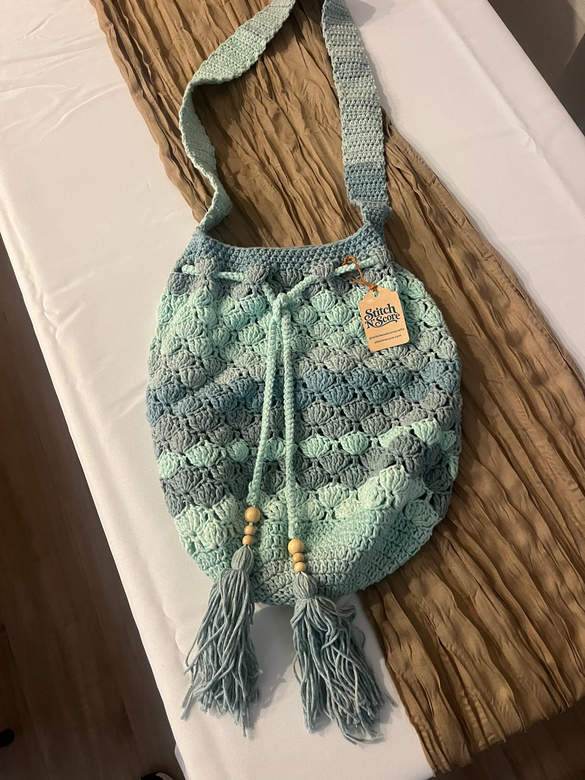 Seaglass crochet drawstring bag with wooden beads and tassels