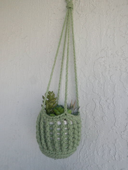 Handmade crochet plant hanger displaying hanging potted plant, crafted by The Crochet Corral
